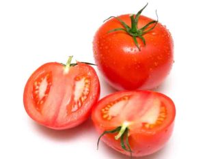 Perfect the tomatoes covered by drops of water are juicy. Isolation on white. Shallow DOF.